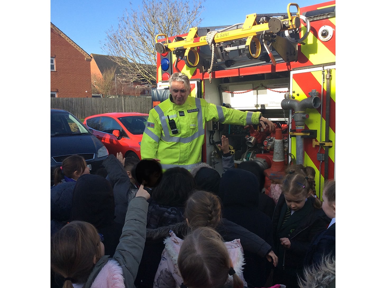 Firefighter showing pupils the fire engine